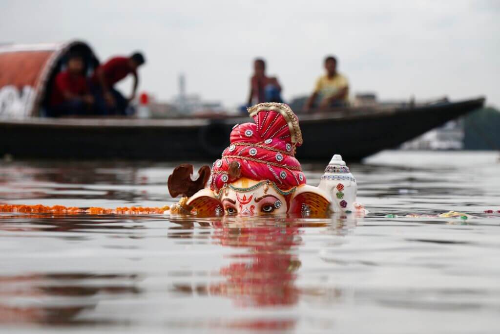 Lord Ganesha Statuette Submerged on Body of Water