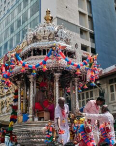 a group of people standing around a float in the street